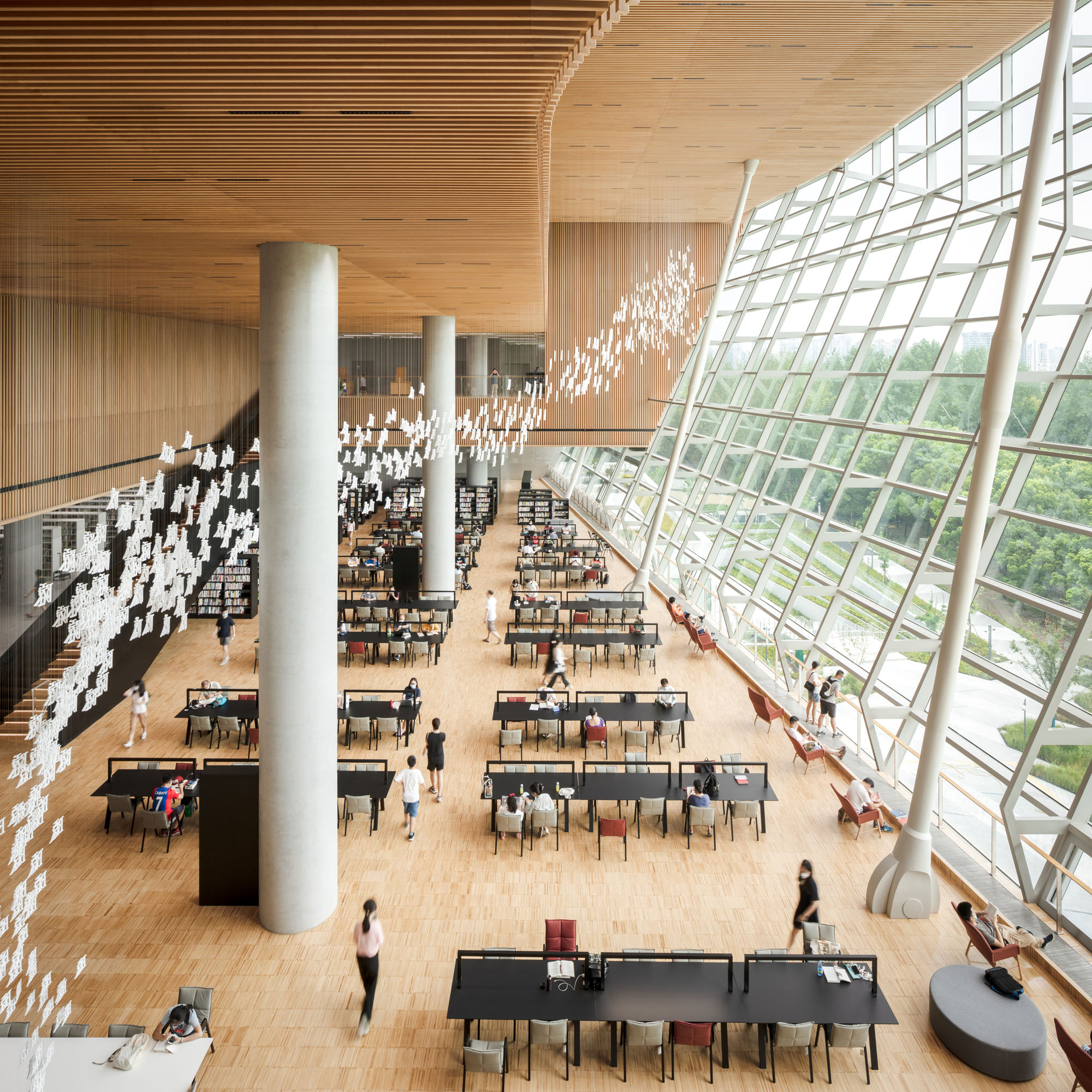 Th interior atrium of the Shanghai Library East with wide views of the surrounding park