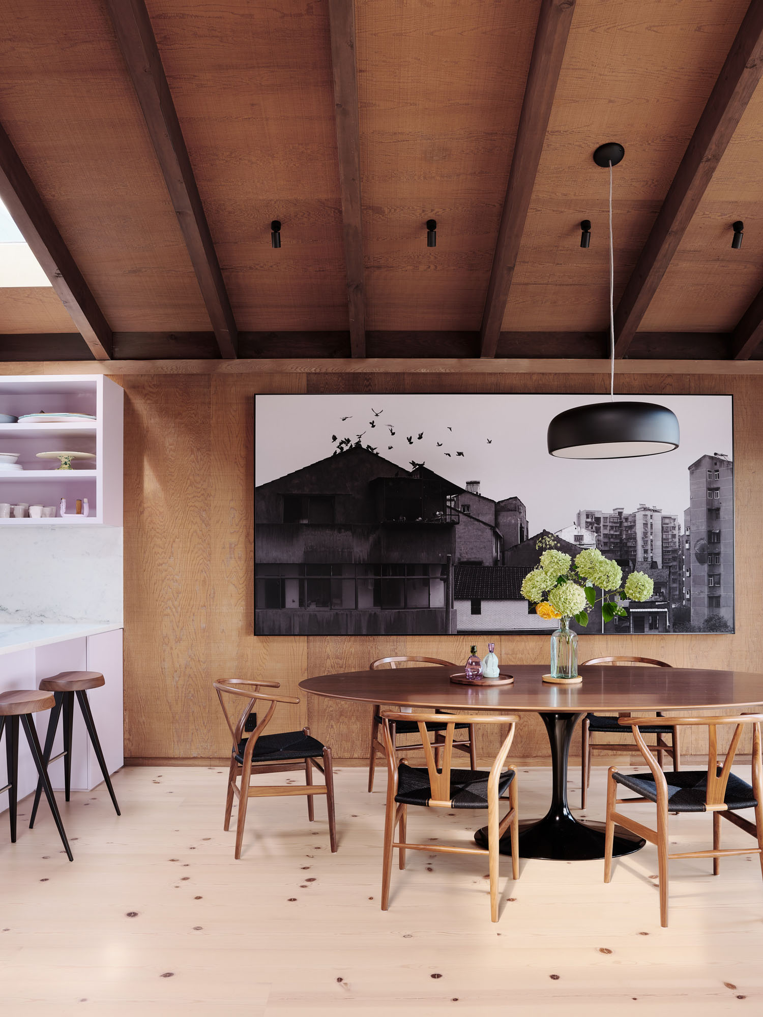 image of a dining room with light wood floors and dark wood ceilings