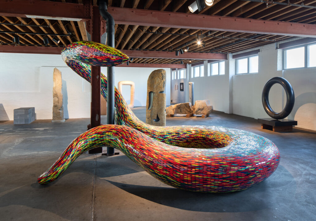 installation view of a large snake sculpture at the noguchi museum
