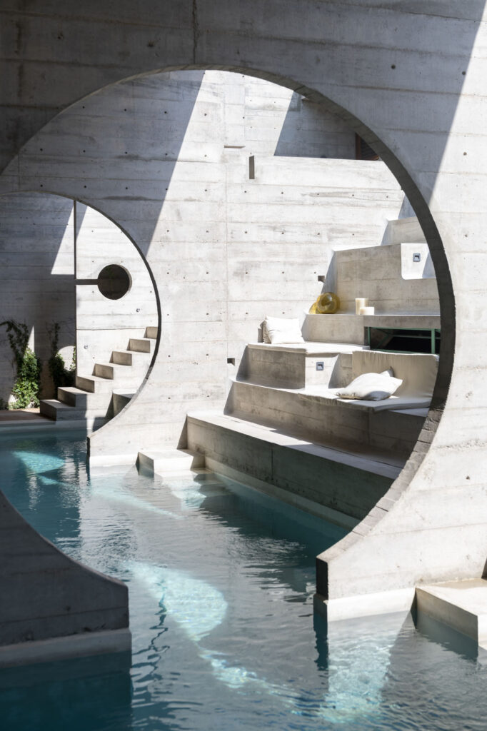 detail view of an infinity pool with concrete walls and apertures