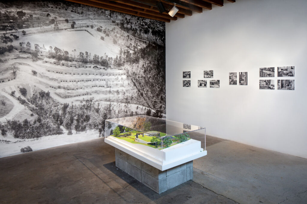 installation view of an architectural model, photographs, and plans at the noguchi museum