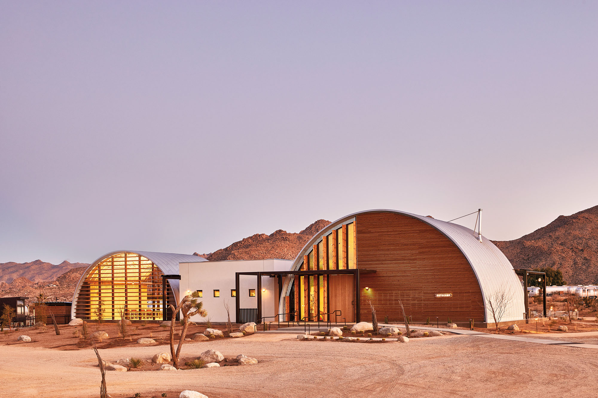 a photograph of two quonset huts transformed into hotels