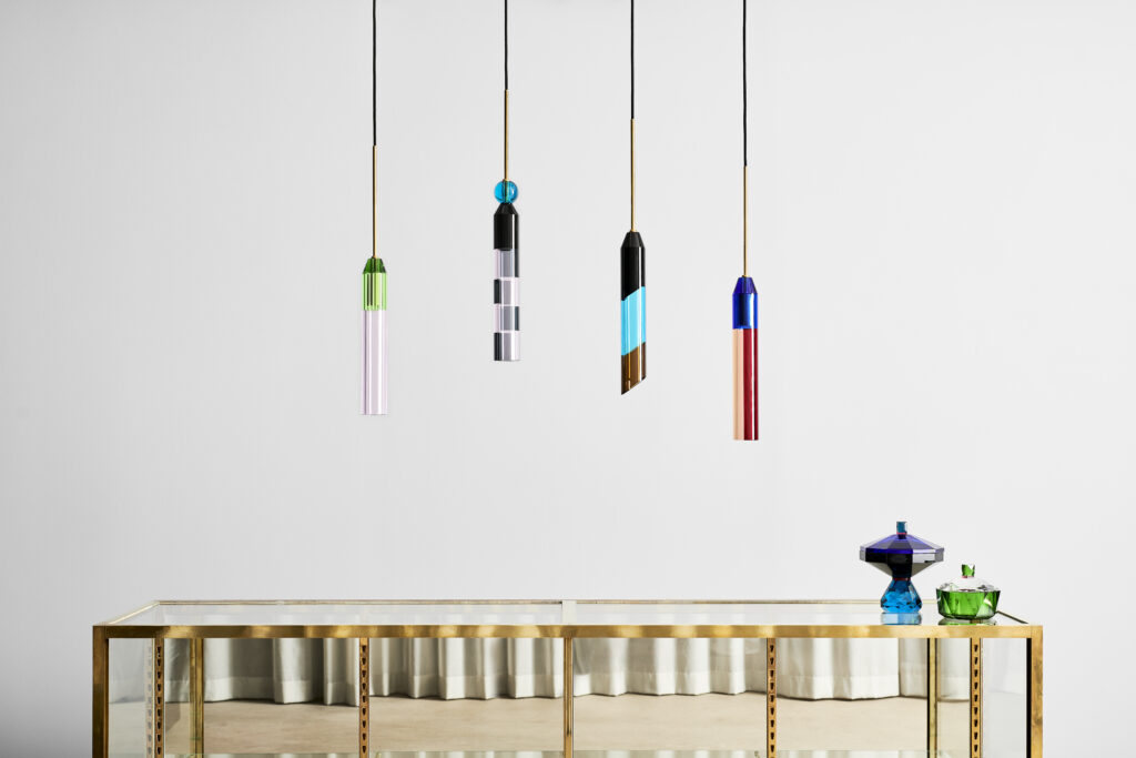 image of four multi-colored glass pendant lights hanging above a table