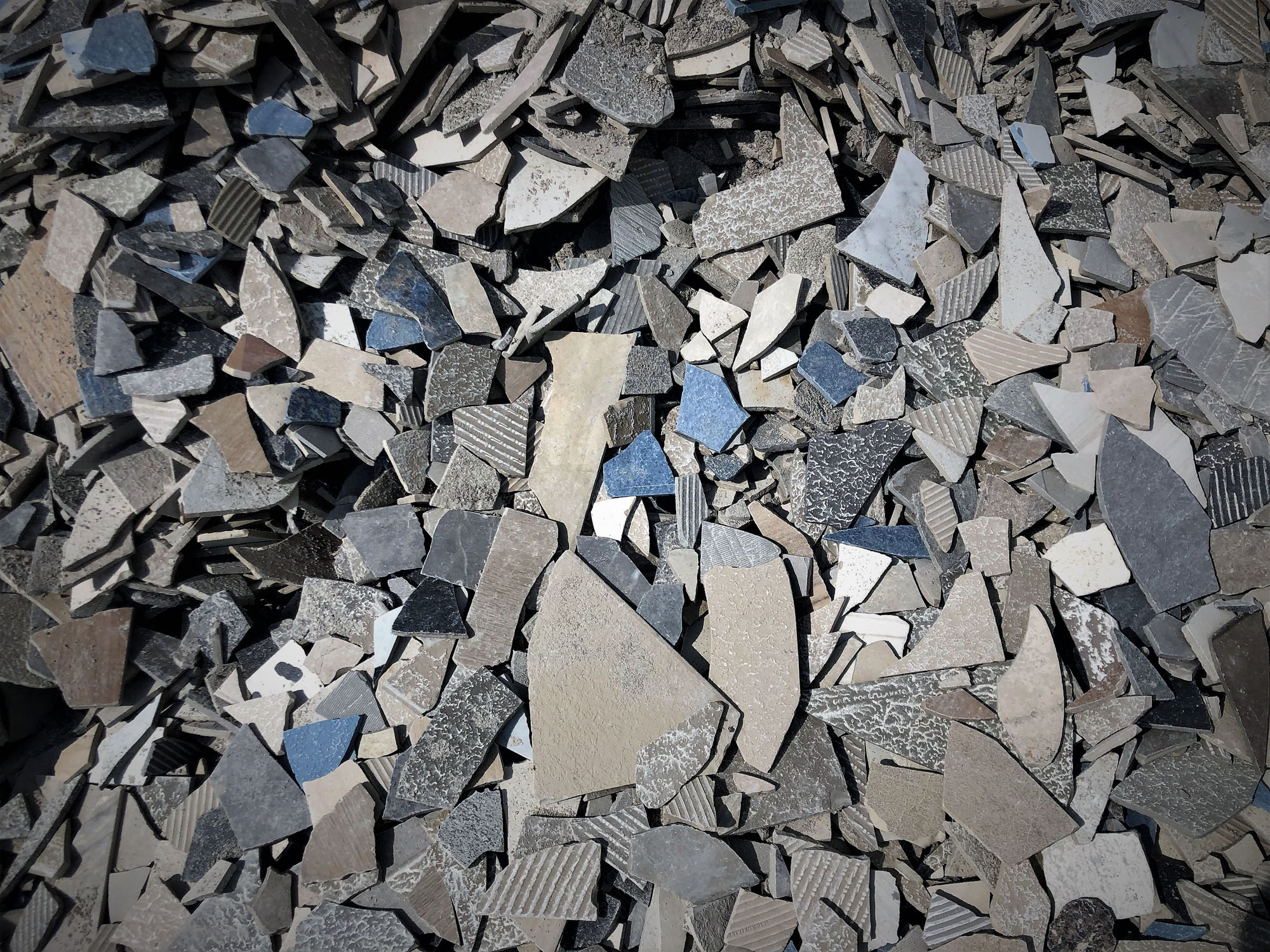 A close-up of a pile of broken bits of ceramic tile.