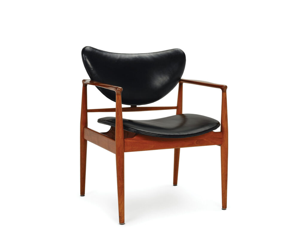 a modernist chair made of wood and leather