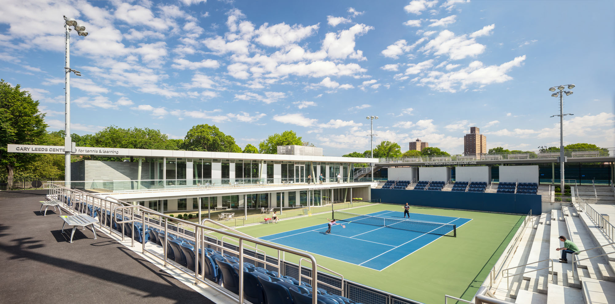 A photograph of a tennis stadium designed by Gluck + for NYJTL