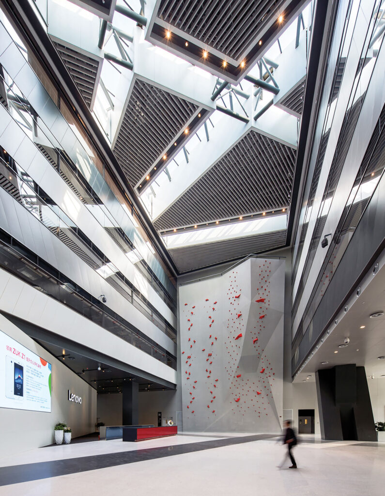 interior of tech company Lenovo's headquarters campus where a  climbing wall is inside an atrium
