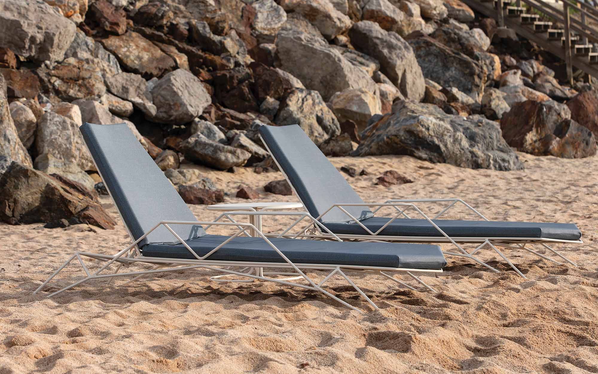 two lounge chairs resting on beach.
iSiMAR Mitjorn Sun lounger.
Designed by Ramón Esteve, 100 percent recycled and recyclable