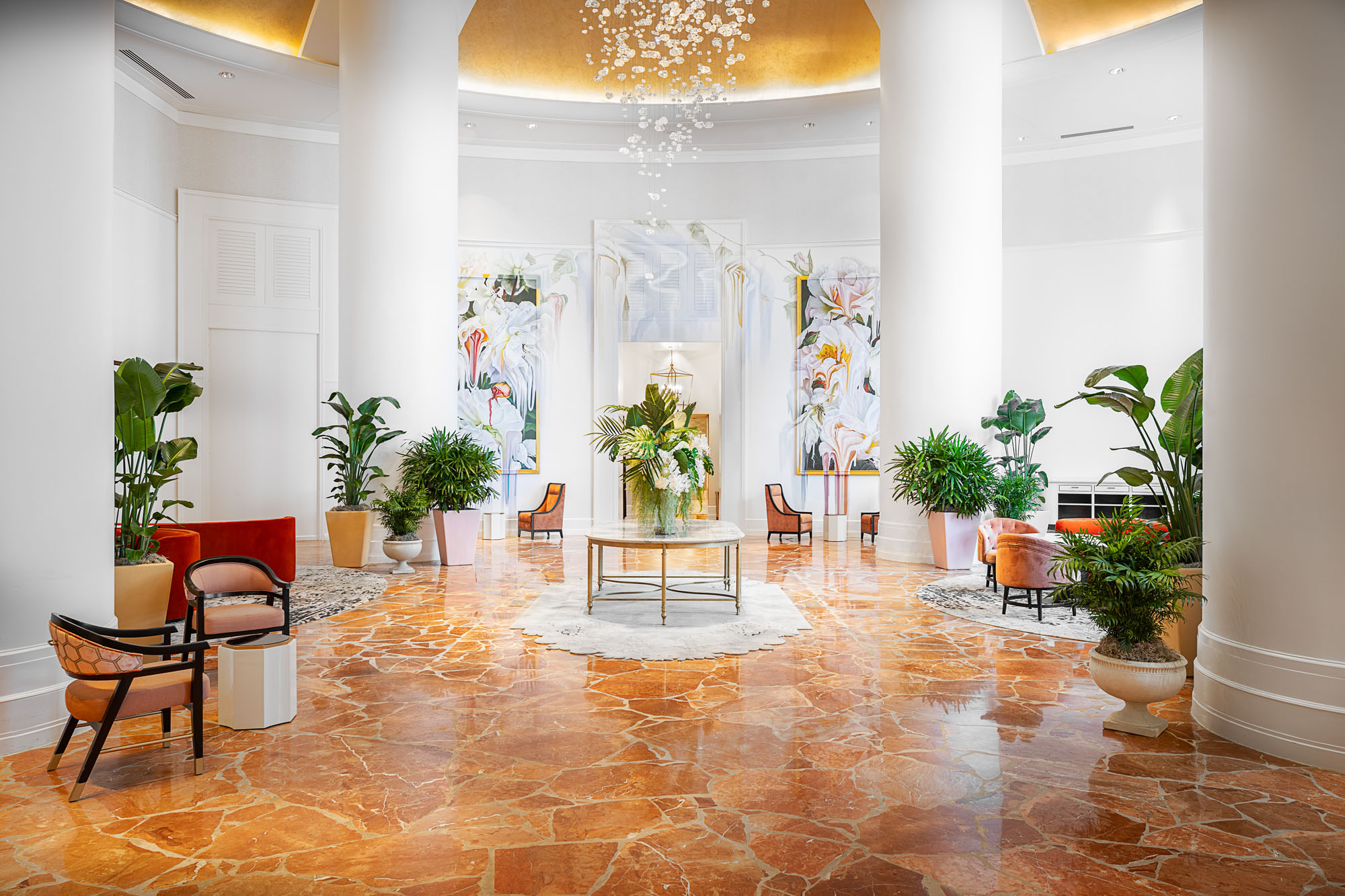 interior image of a hotel lobby with marble floors and white walls