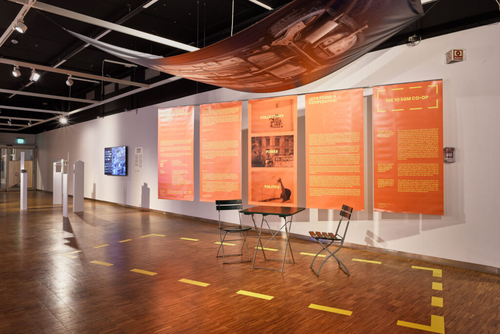 image of an exhibition with a table and chairs