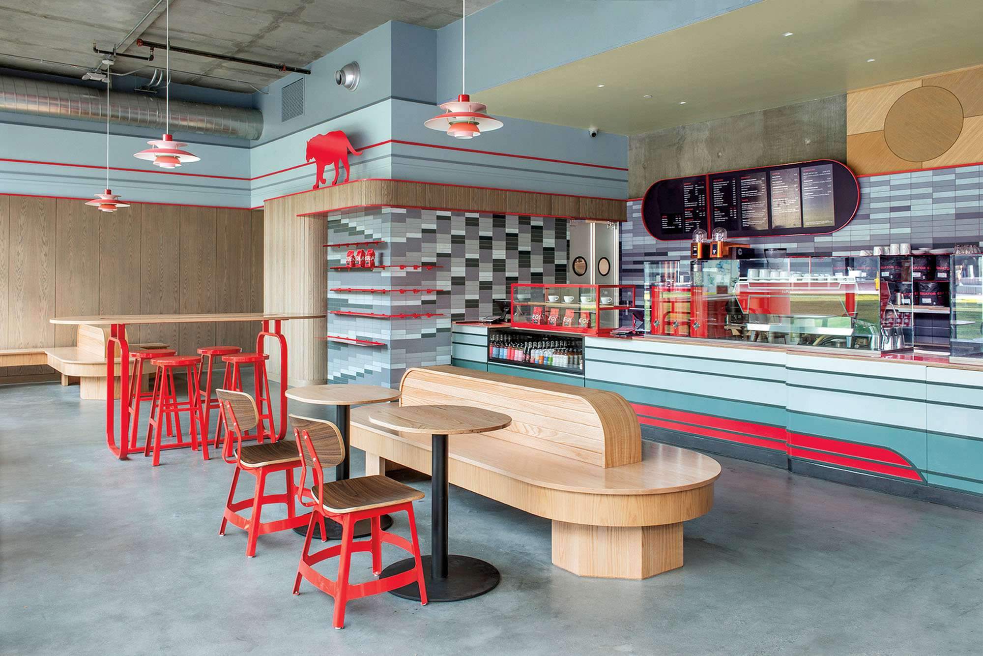 A photograph of the interior of a coffee shop with red and blue accents