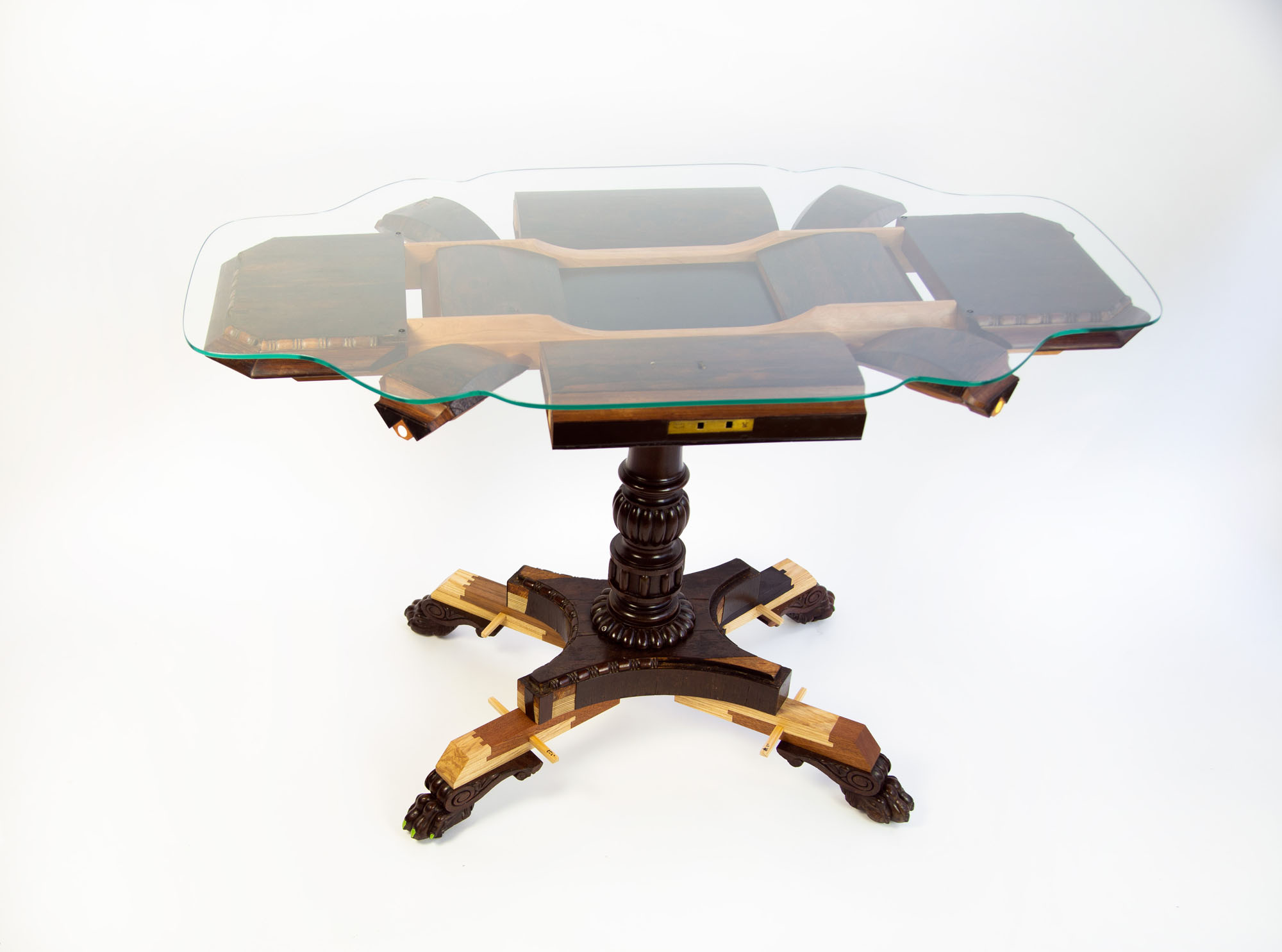 an image of a deconstructed sewing chest turned into a glass table. 