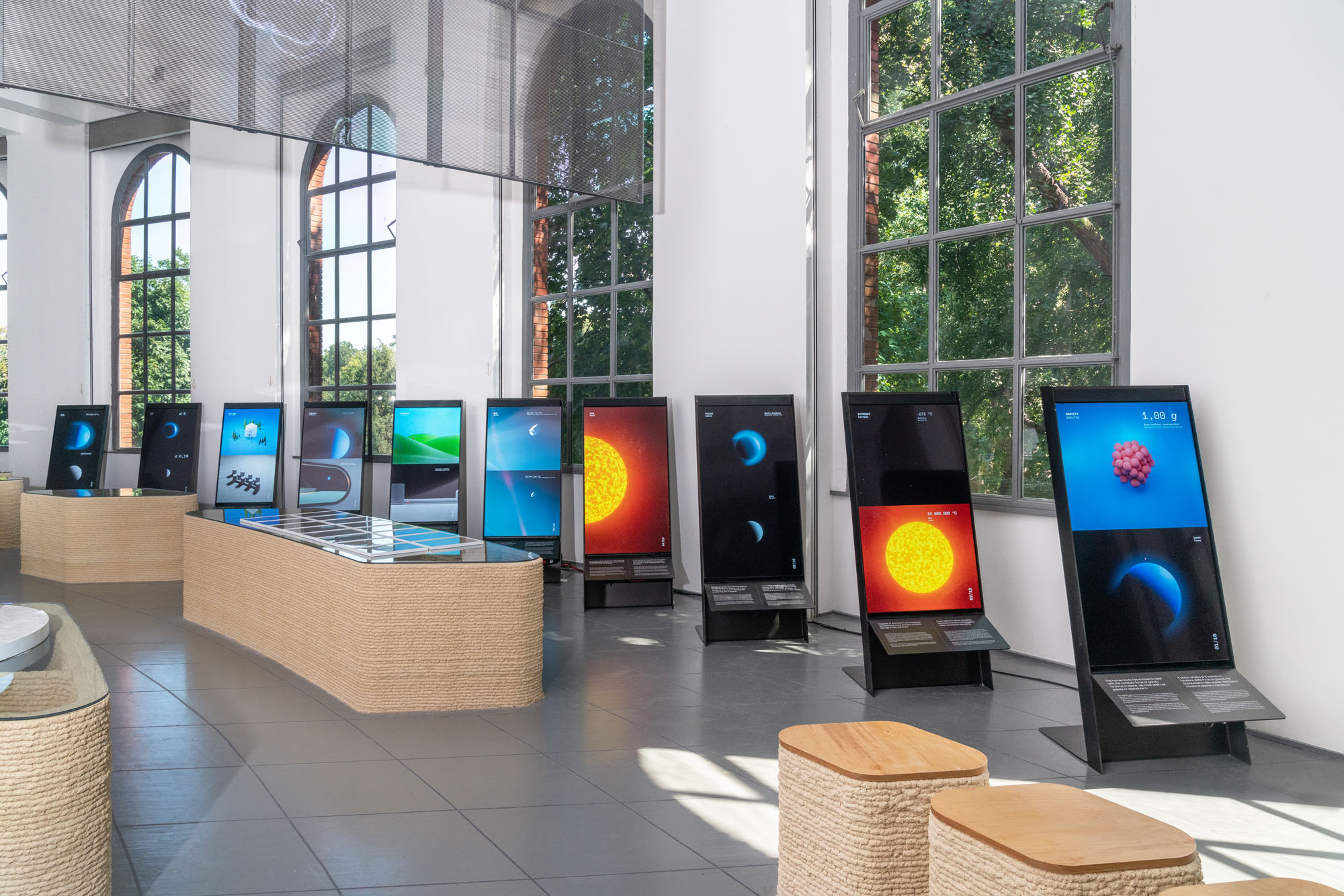 a series of screens showing images of the solar system at unknown unknowns an introduction to mysteries at the Milan Triennale