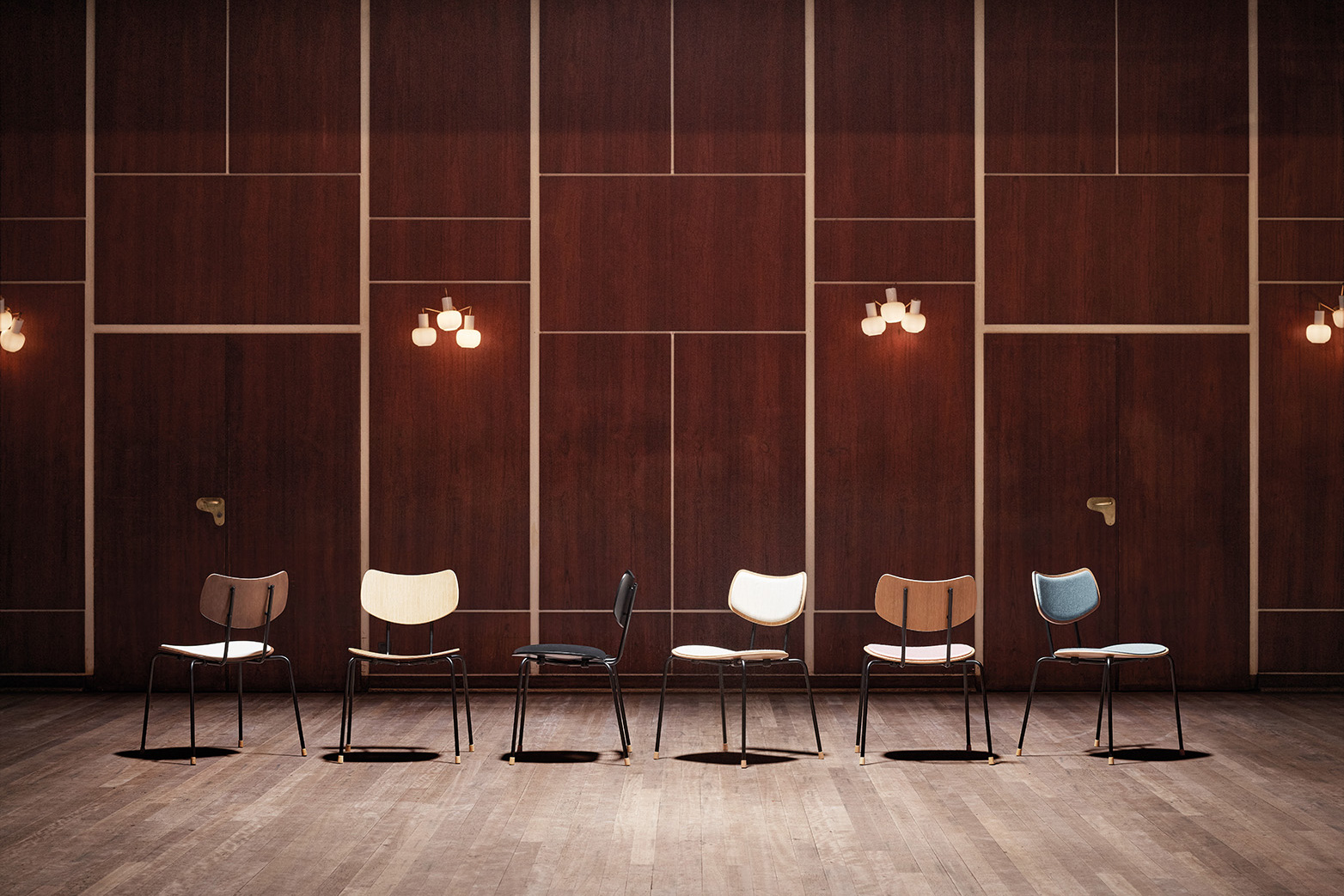 interior of the Vega Music Venue in Denmark with wood-clad walls and a selection of chairs on display
